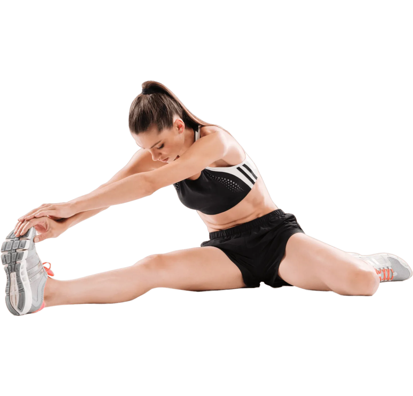 Woman reaching toward her foot in a seated leg stretch