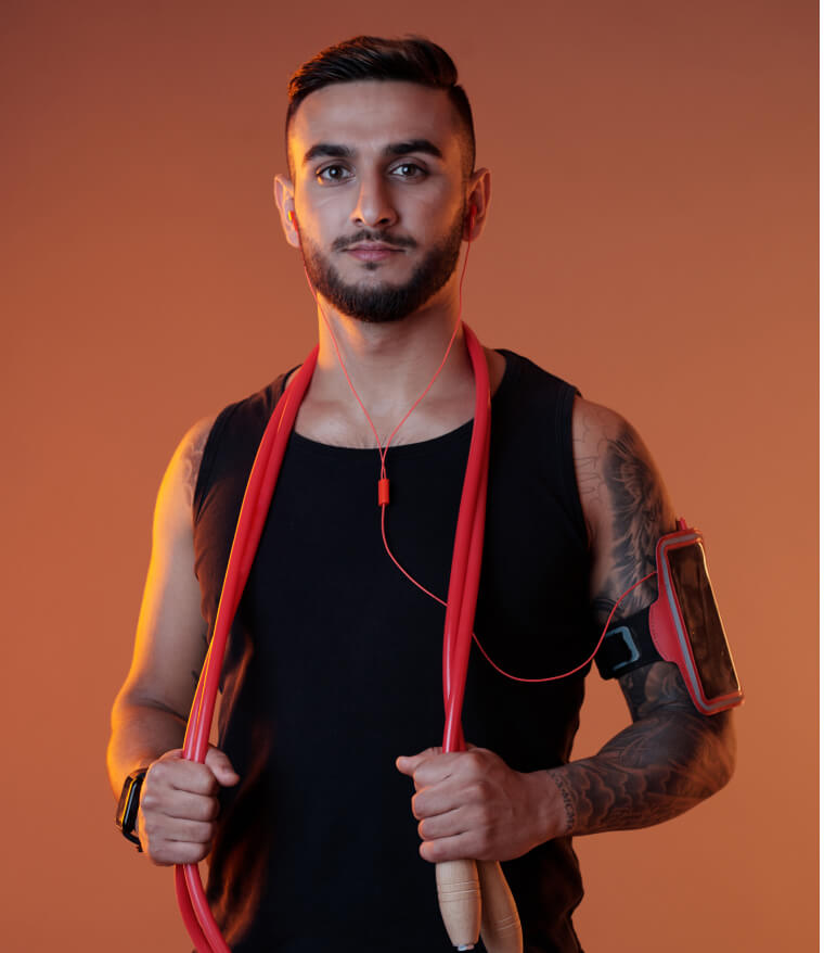 Man holding a red resistance band over his shoulders