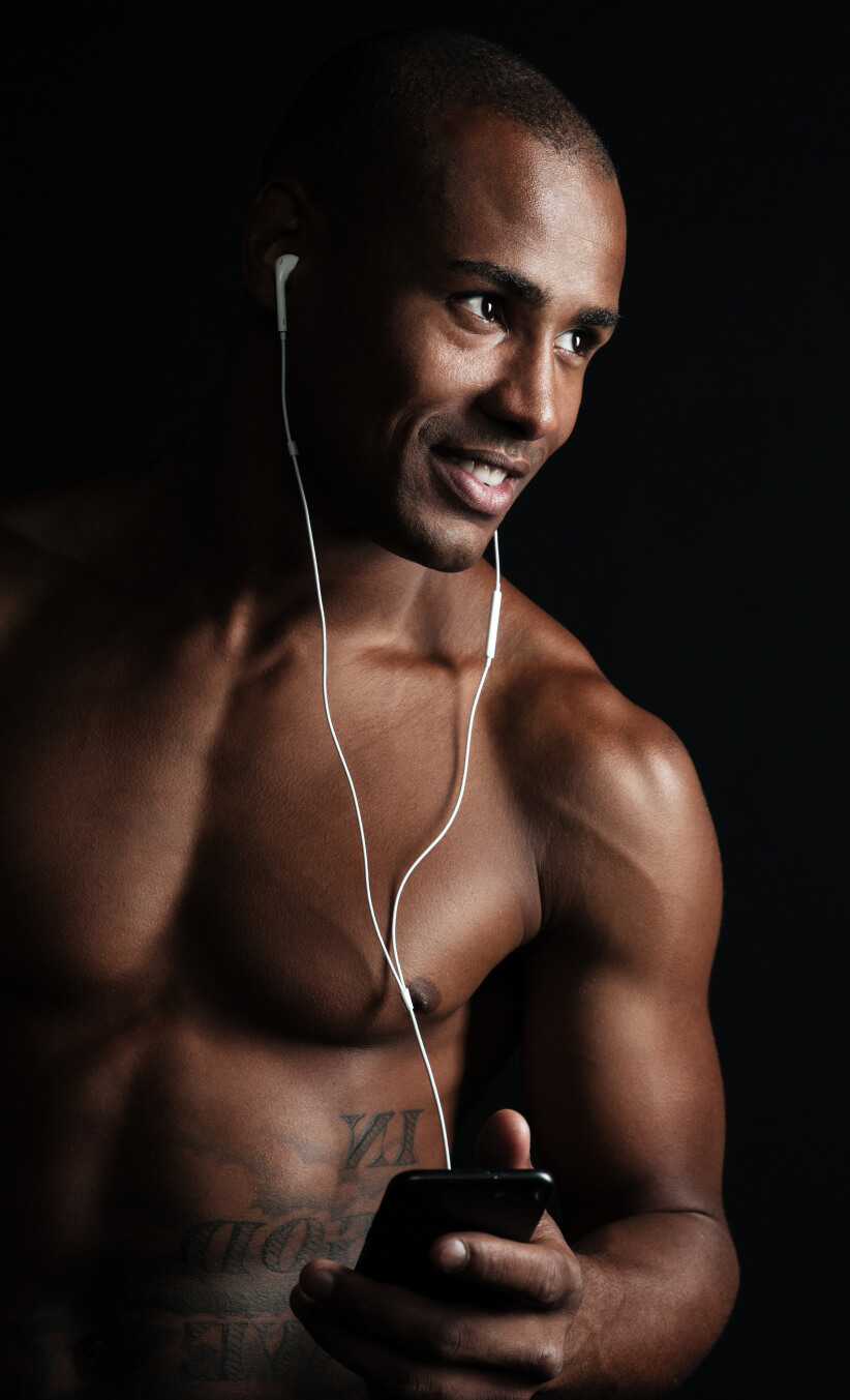 Man wearing earphones and holding a phone