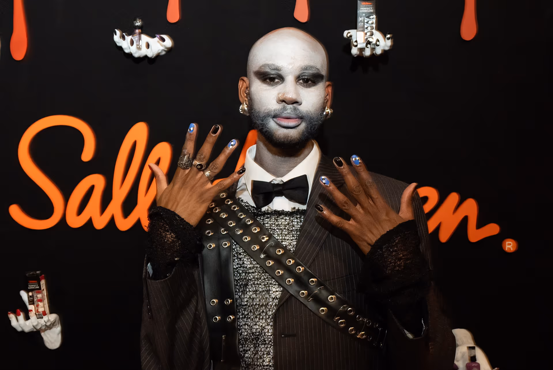 Man showing off colorful nails at the Sally Hansen Halloween launch event.