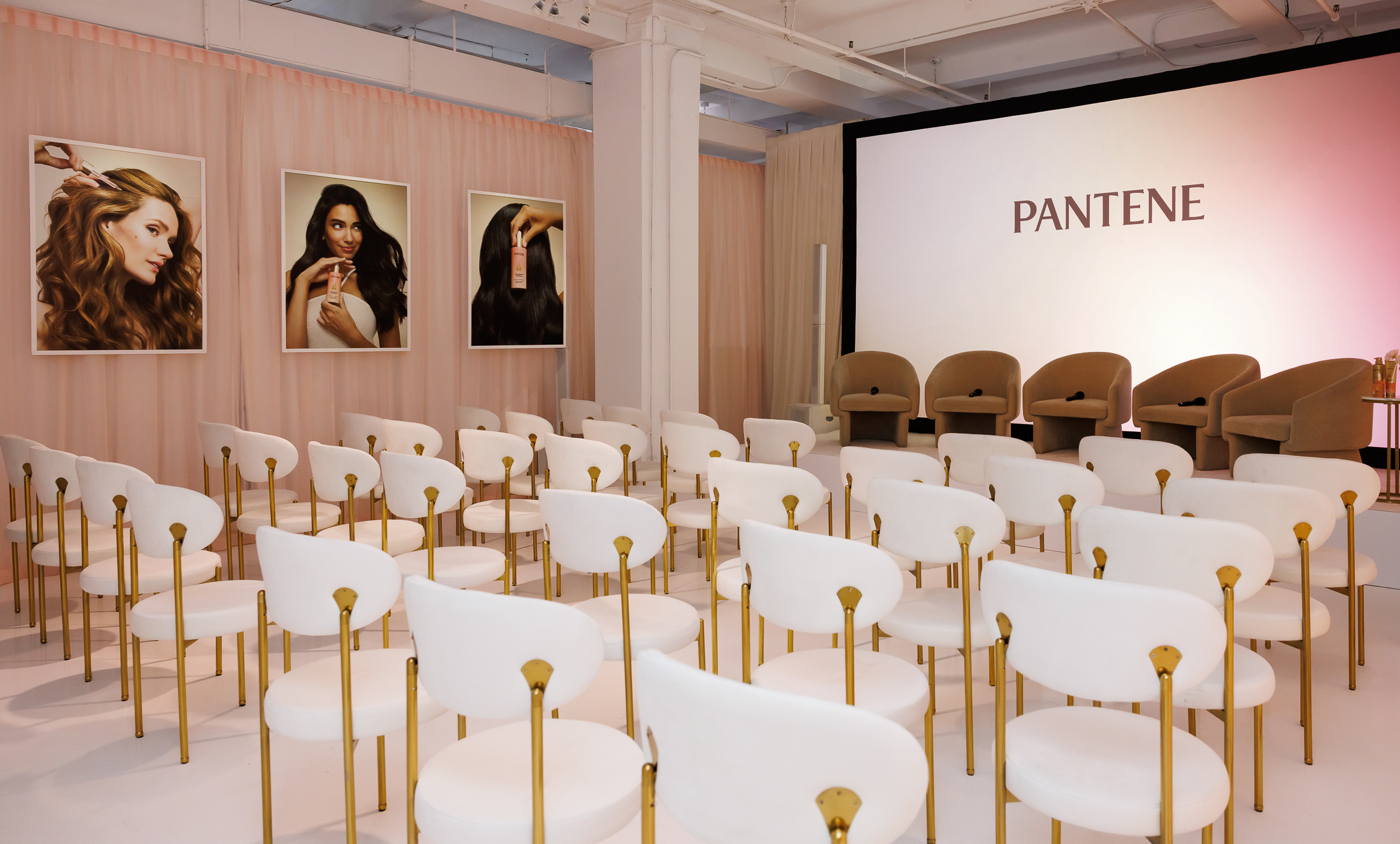 Close-up of playful, custom-built installations in bright pink and yellow tones, decorated with tropical flowers and product branding, designed to reflect the soft-focus effect of the Skin Tint.
