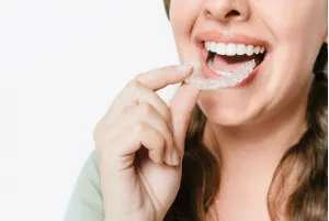 A girl captured while applying clear aligners. 