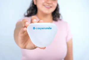 A girl holding Caspersmile Clear Aligners in their case