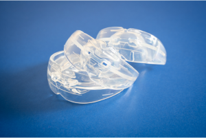 An image of 3 transparent mouthguards