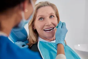 A dentist treating an elderly woman