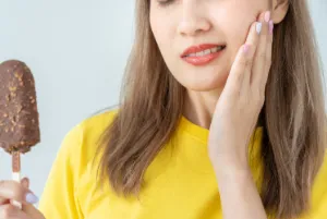 A woman experiencing teeth sensitivity
