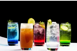 Multi colored sugary drinks on a table