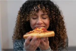 A woman eating pizza