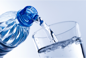 Water pouring from a bottle into a glass