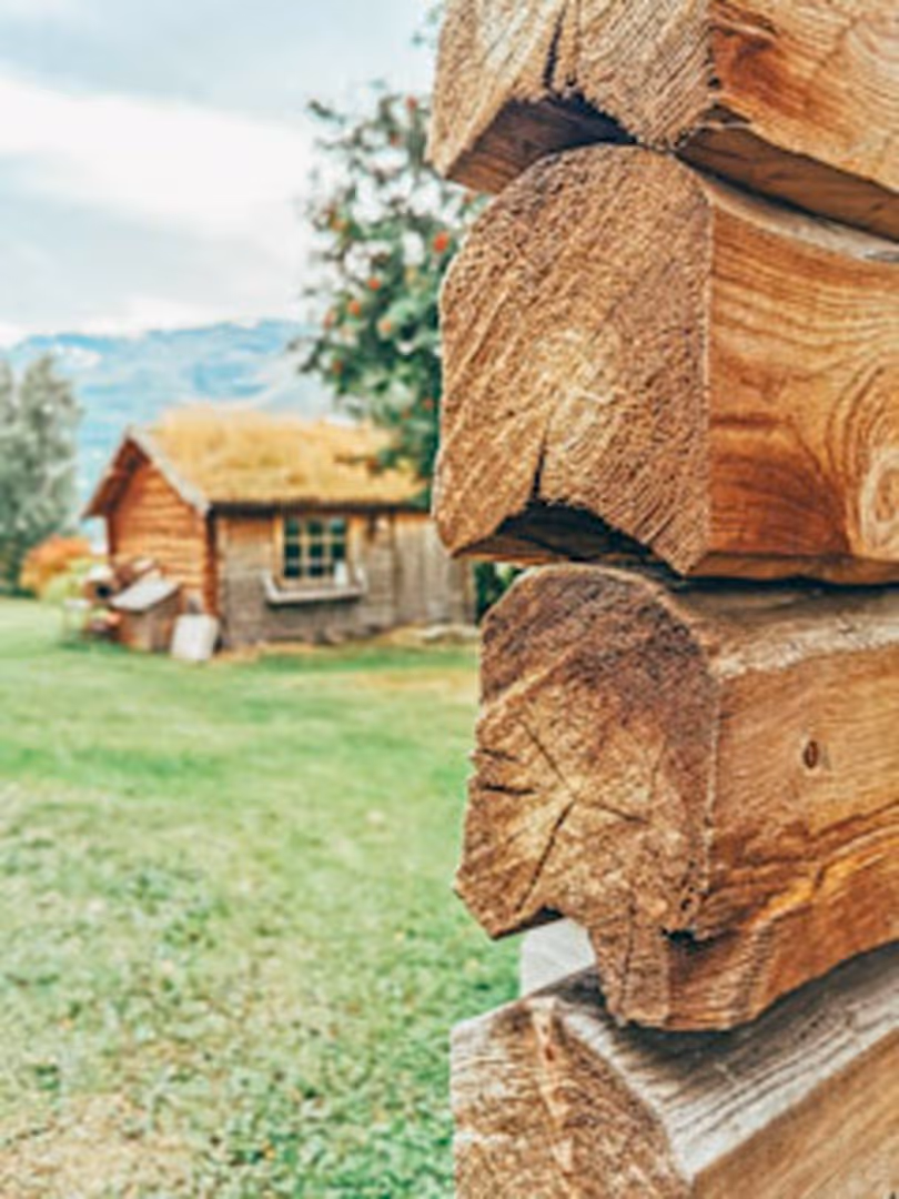 Old log house with a log gate in front of