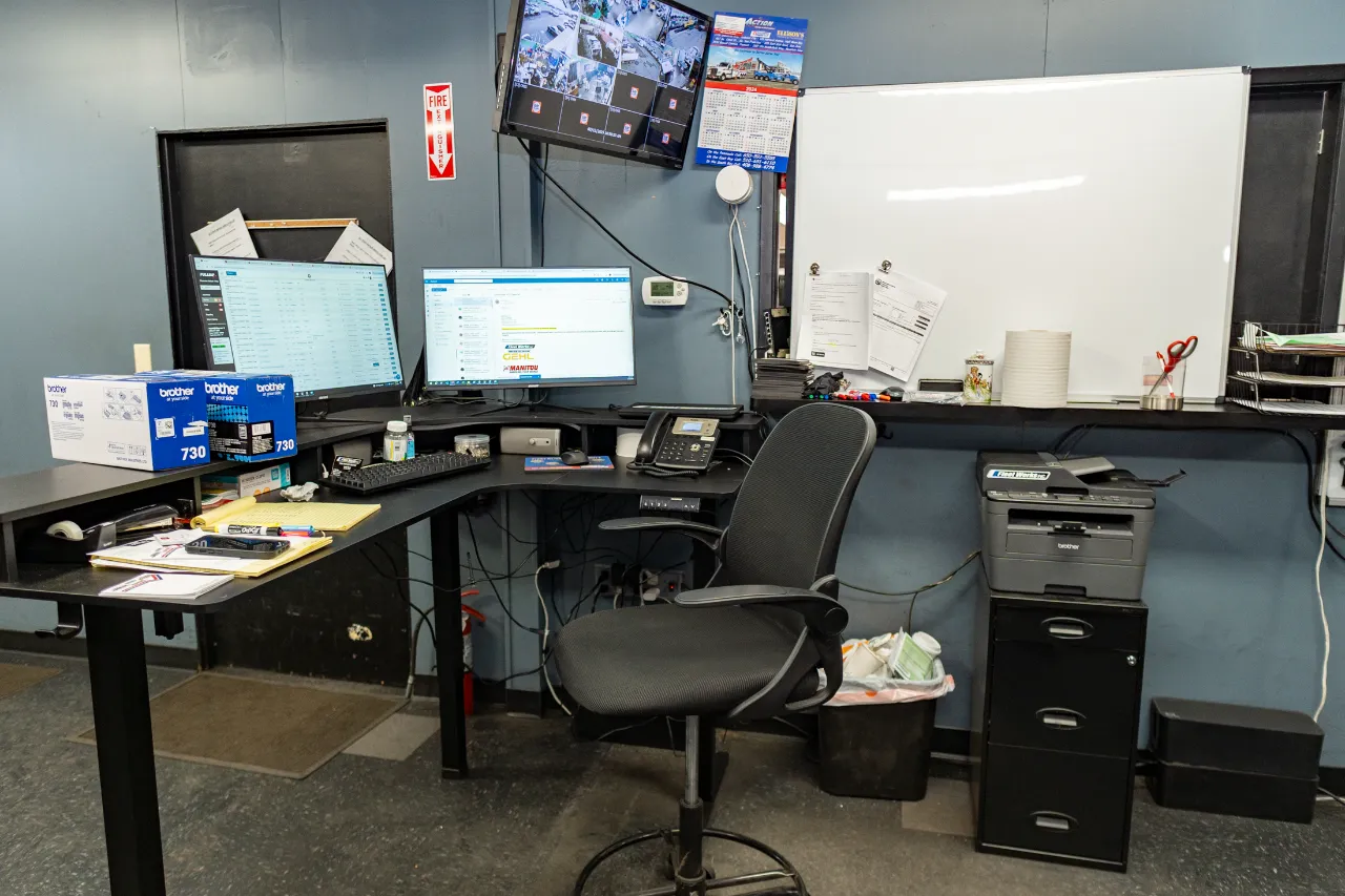 Service Dispatch workstation with dual monitors, CCTV screen, whiteboard, and Brother 730 toner boxes.