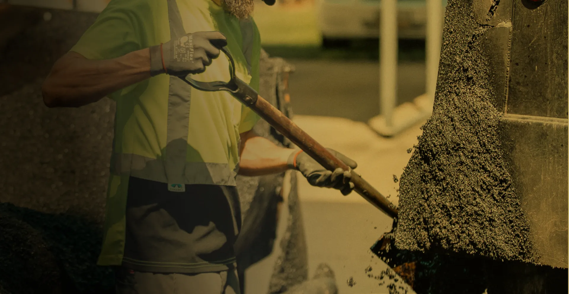 gold overlay of worker shoveling concrete