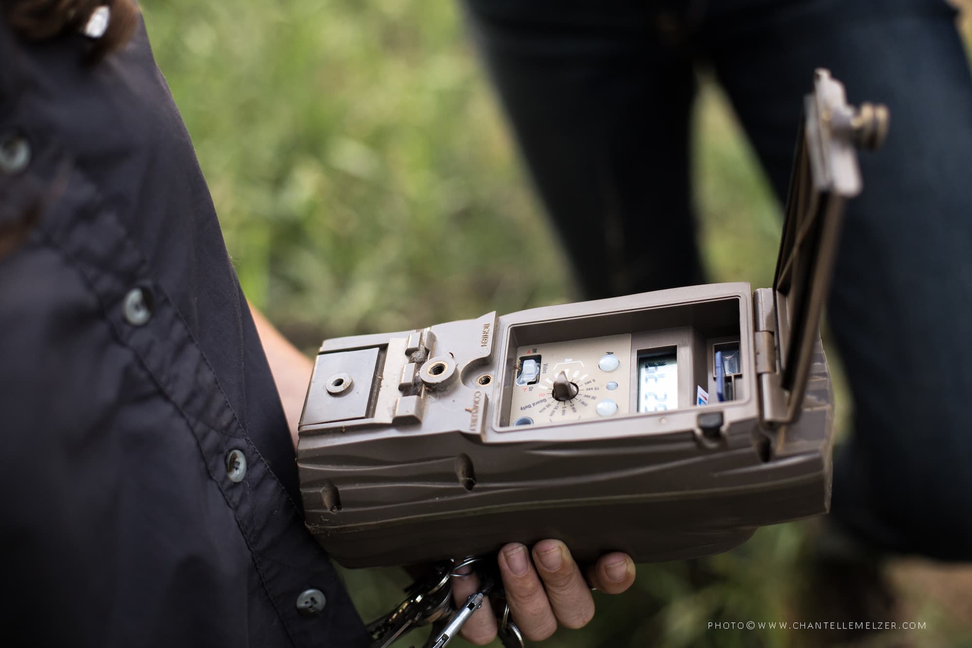 A person holding the camera trap housing that protects the camera inside