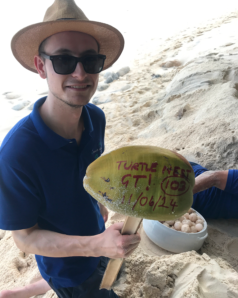 A team of marine conservation volunteers working together on a sea turtle conservation program near the nesting beach