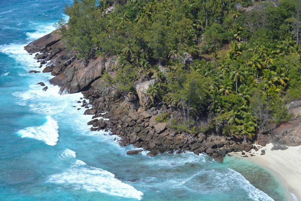 An aerial view of North Island, Seychelles, showing pristine beaches and successful marine habitat restoration efforts.