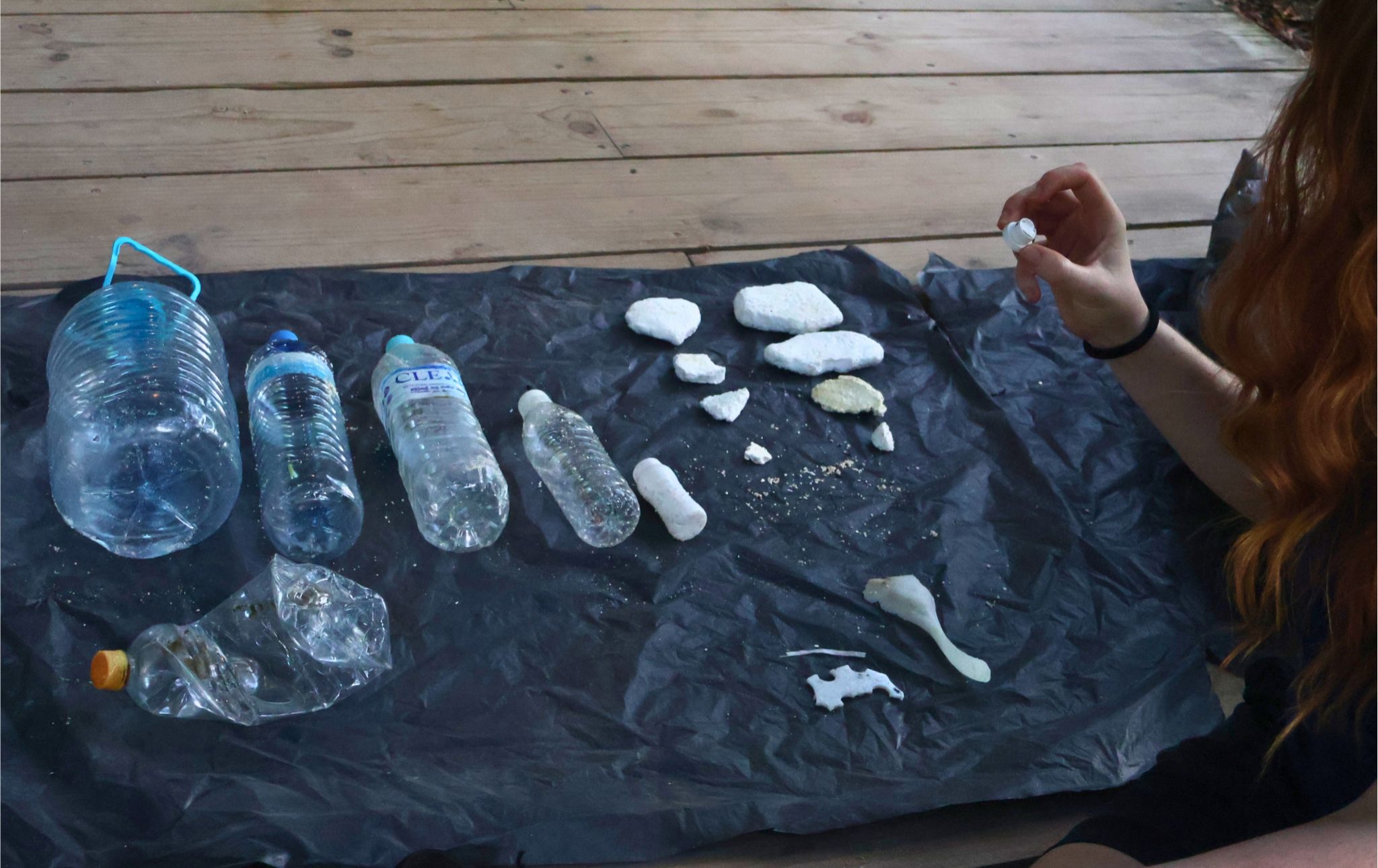 A volunteer organises marine litter into categories