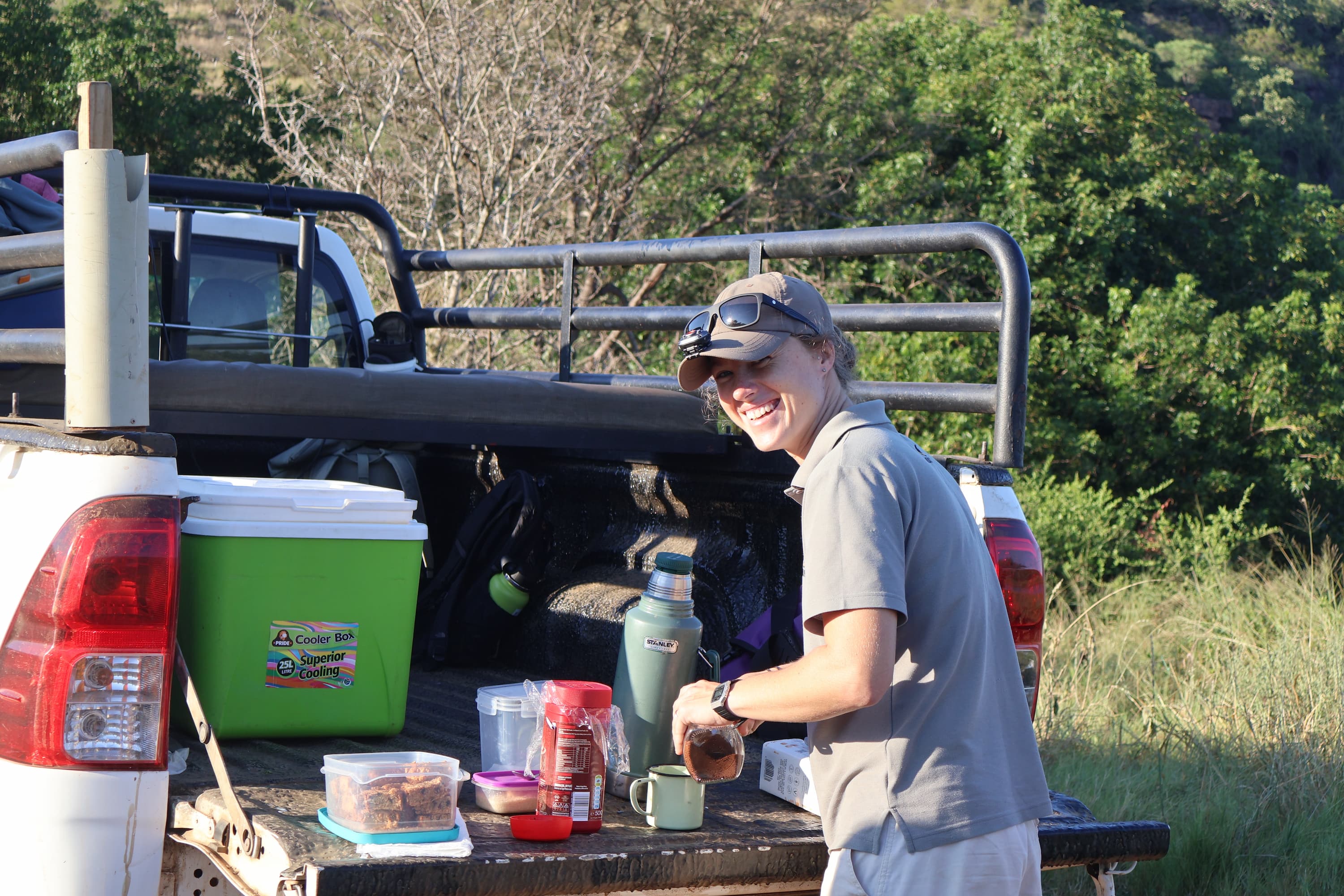 A Wildlife ACT Priority Species Monitor preparing coffee at a bush coffee stop.