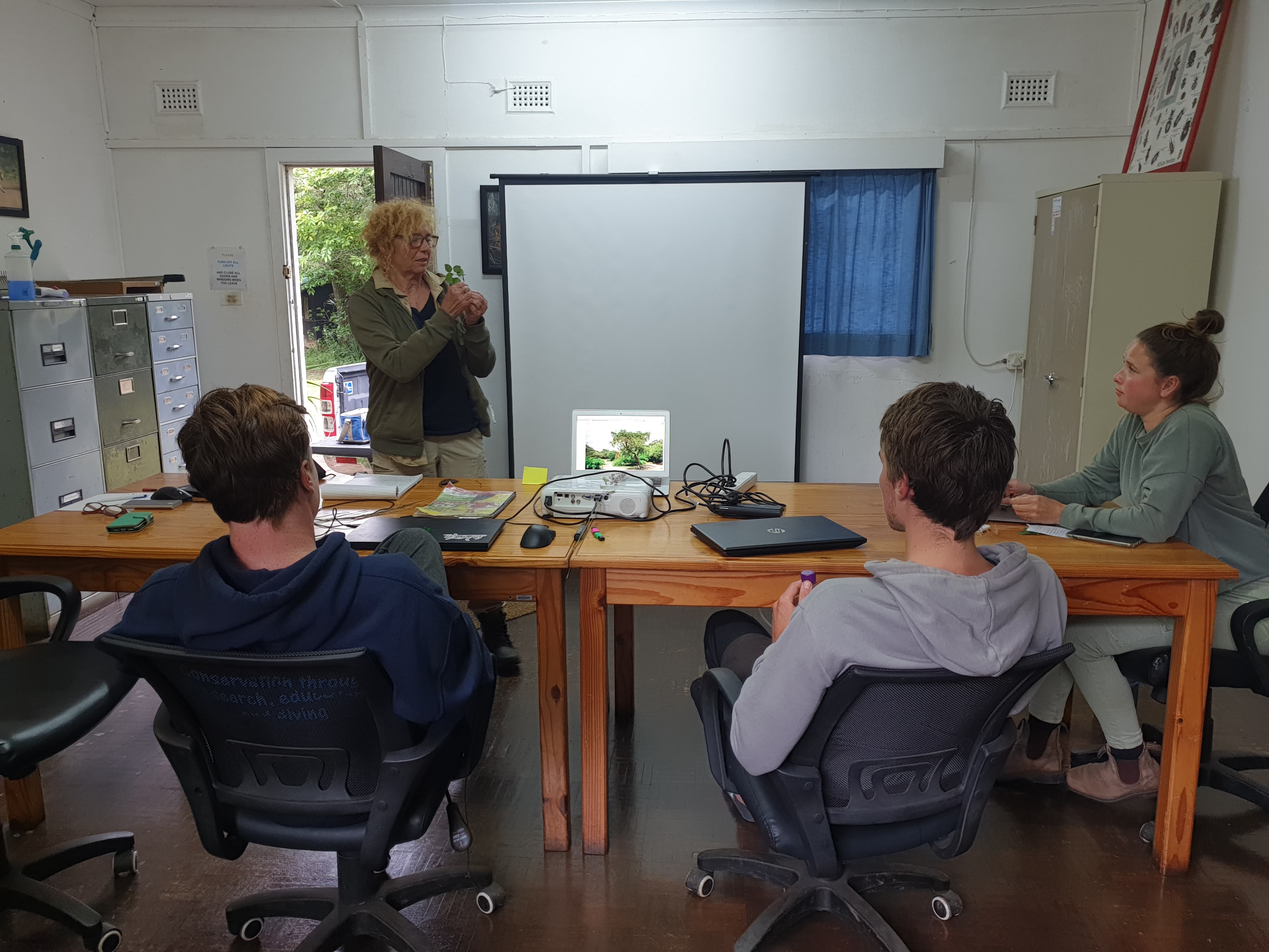 Course participants presenting to their group in the classroom
