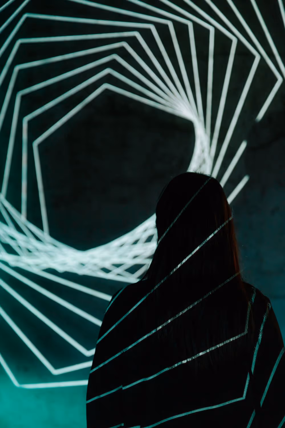 Abstract lines projected on person in the front and wall