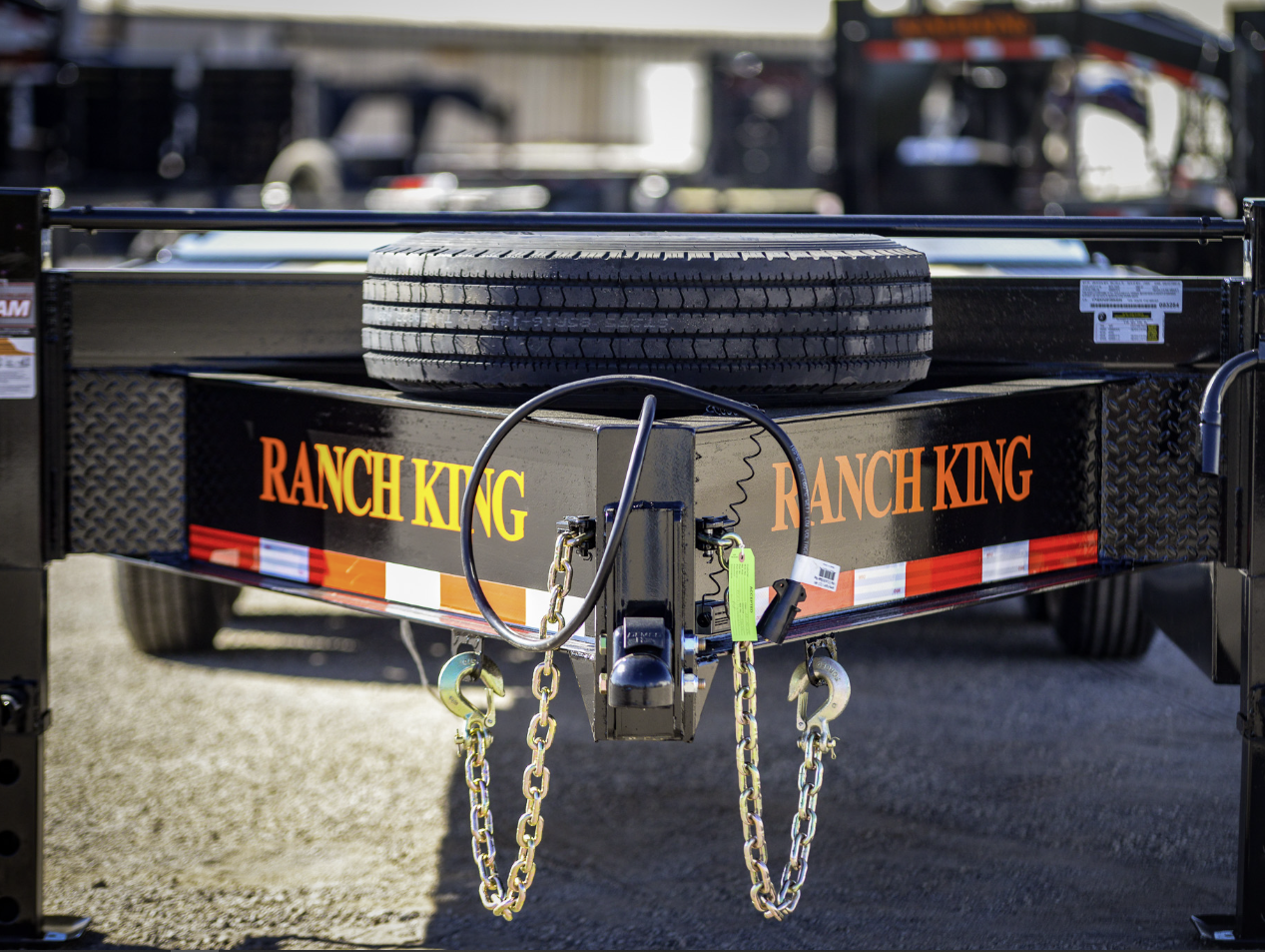 Truck towing a flatbed trailer at sunset