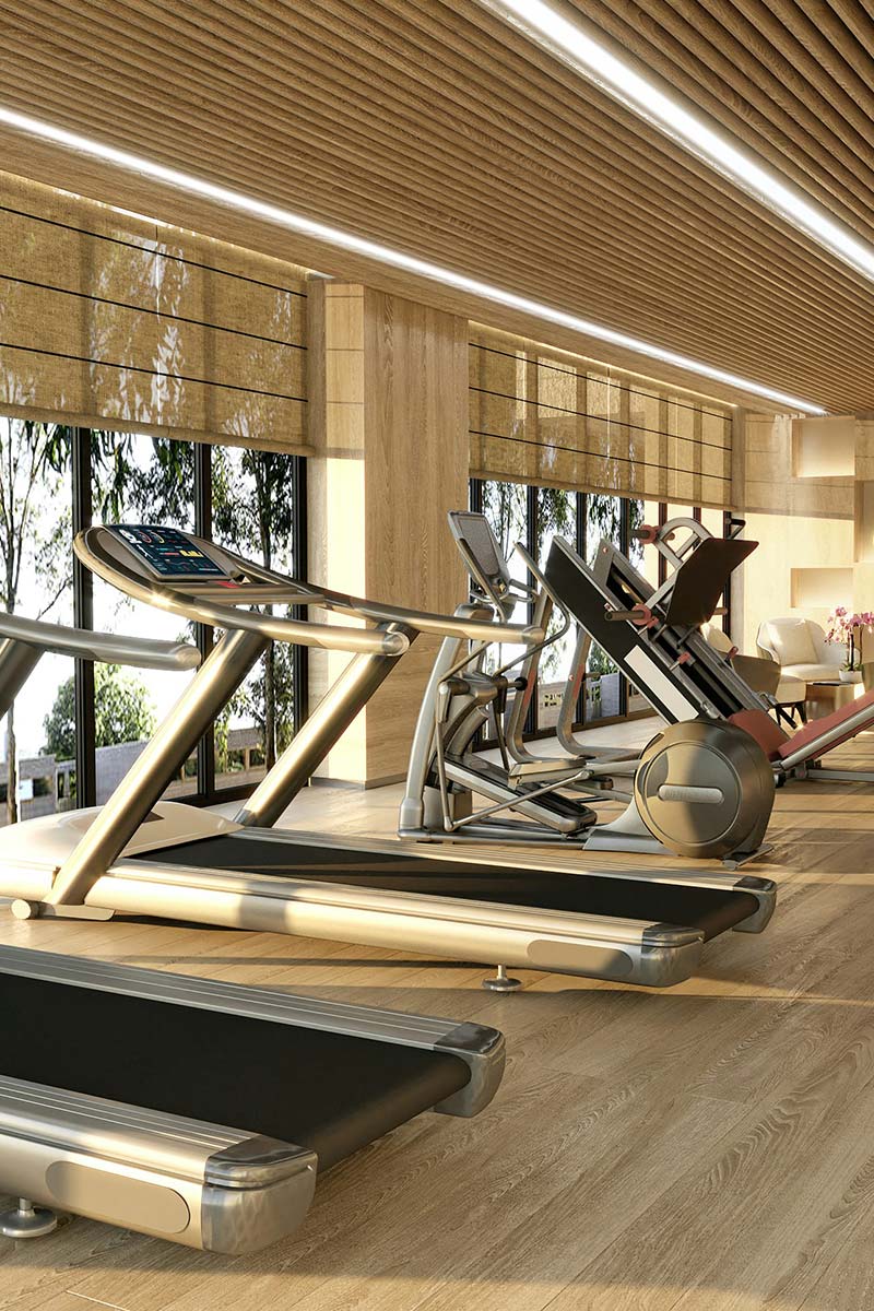 Row of treadmills in a bright, modern gym setting