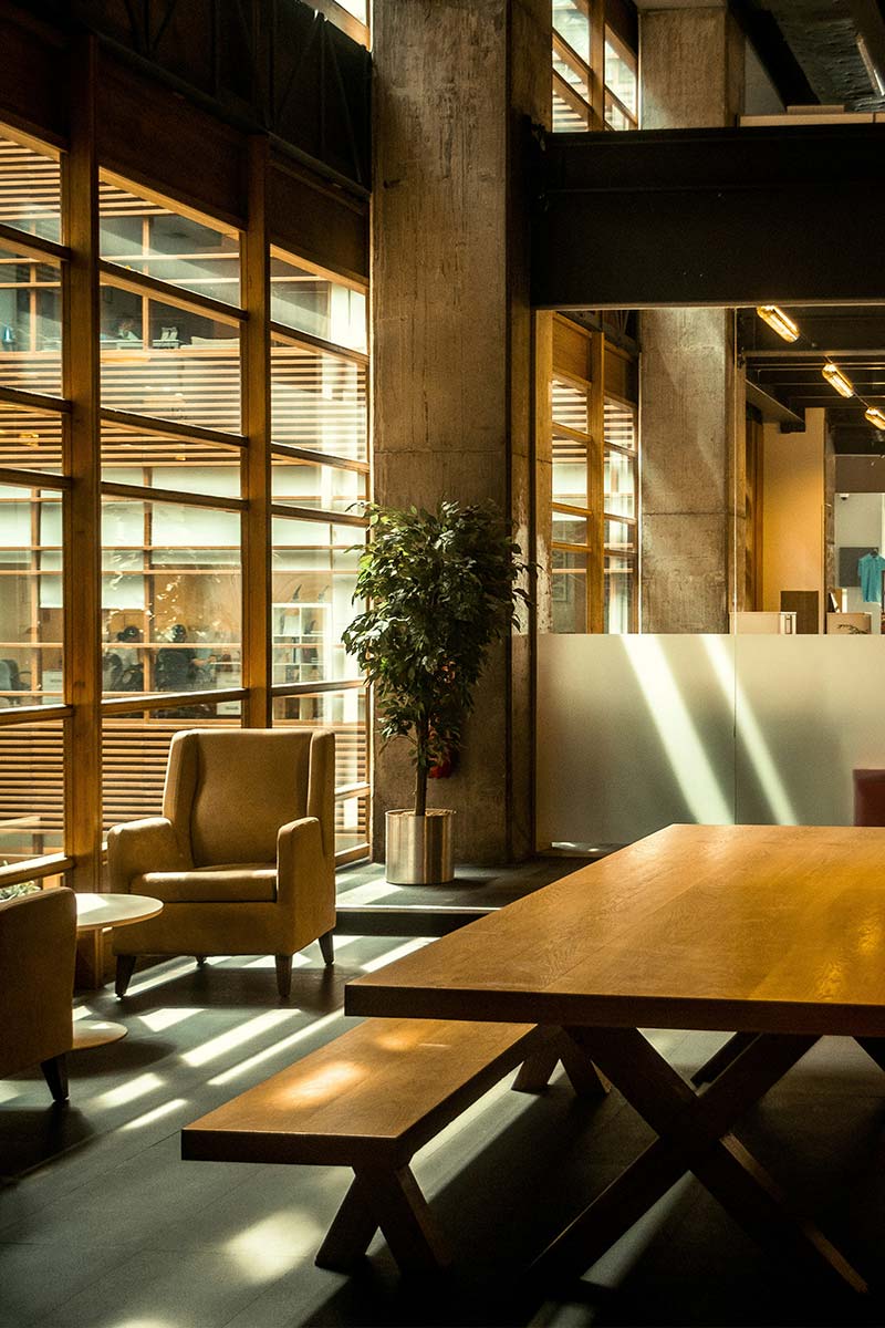 Modern coworking space with light filtering through glass windows