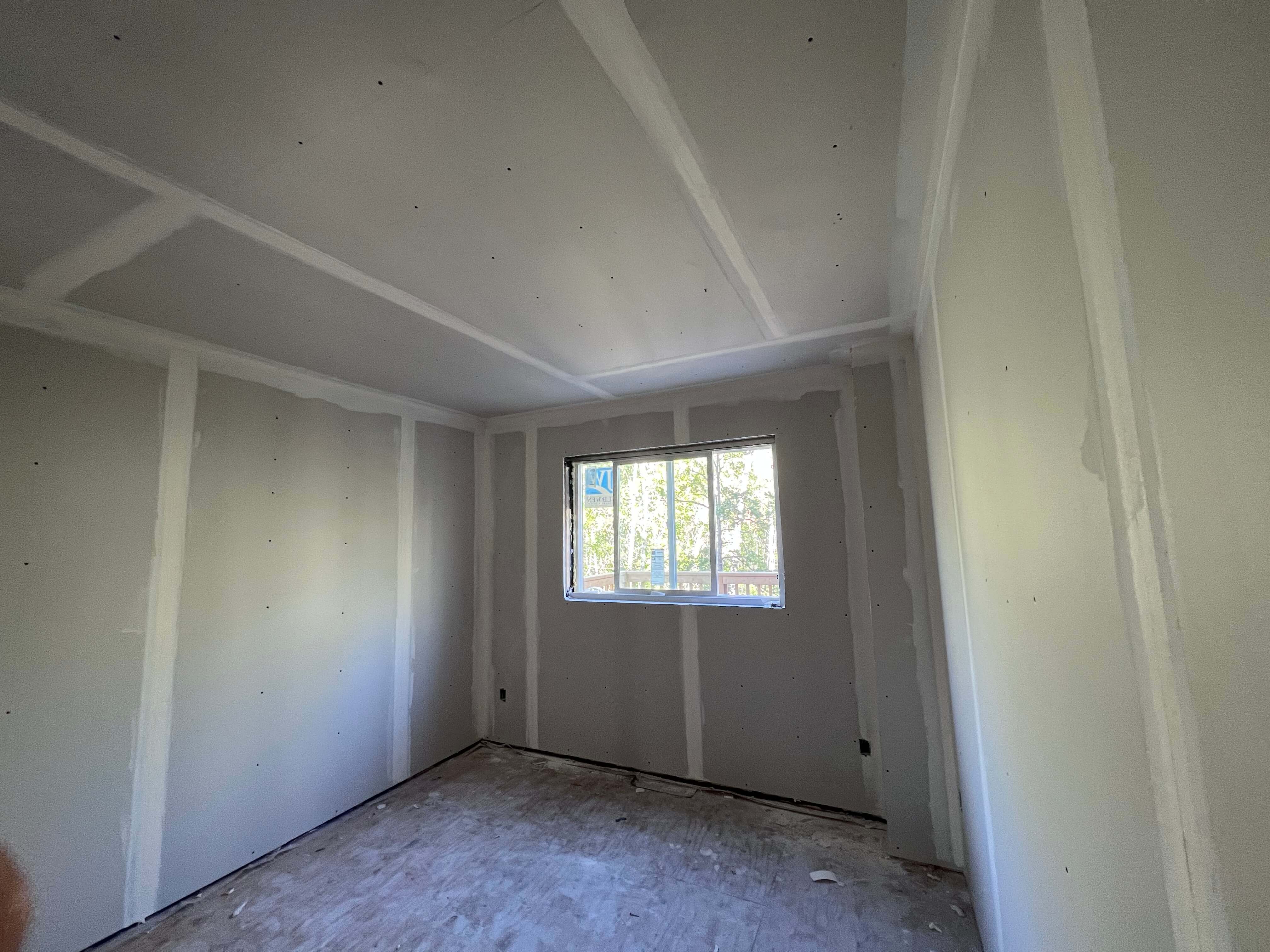 Newly installed drywall and completed finish work ready for paint