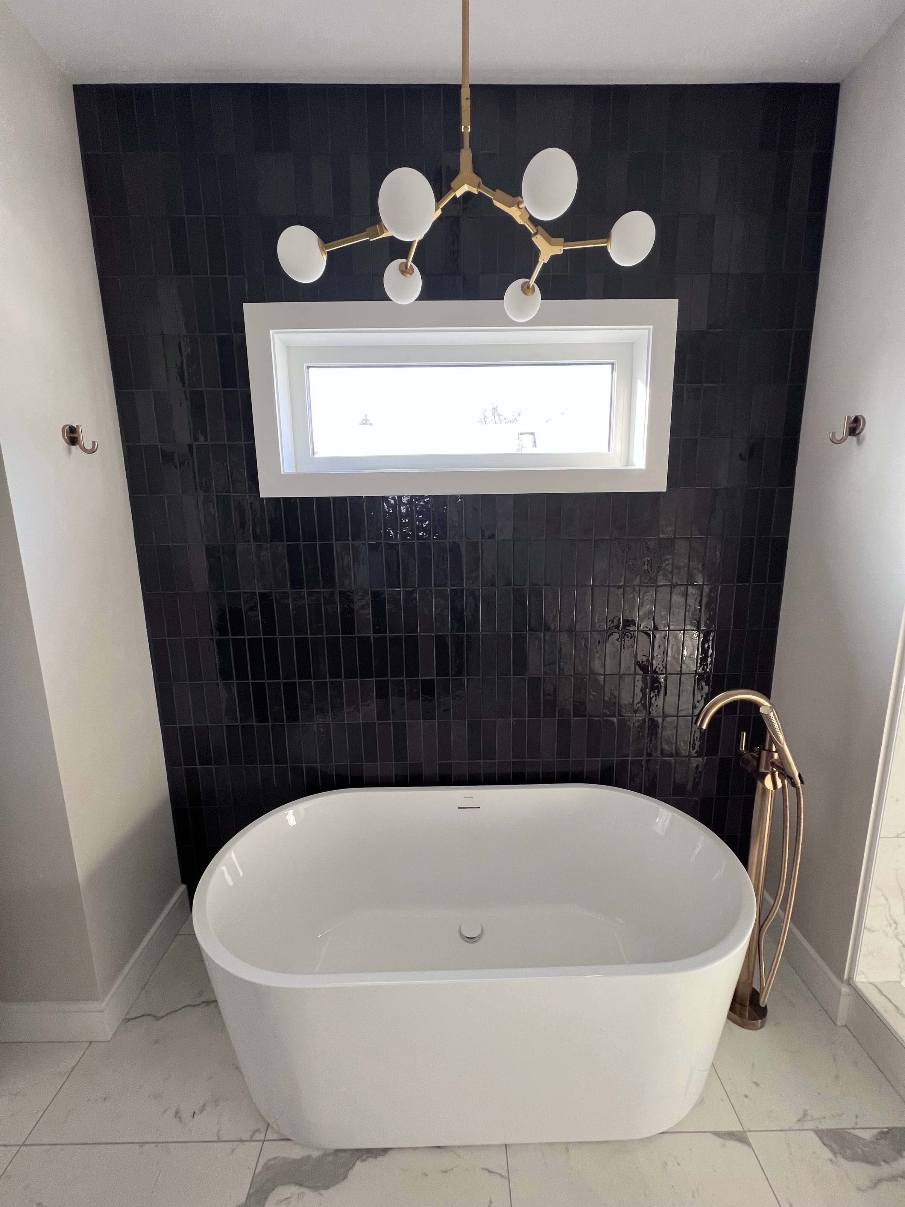 Classy bathtub with dark tiled background 