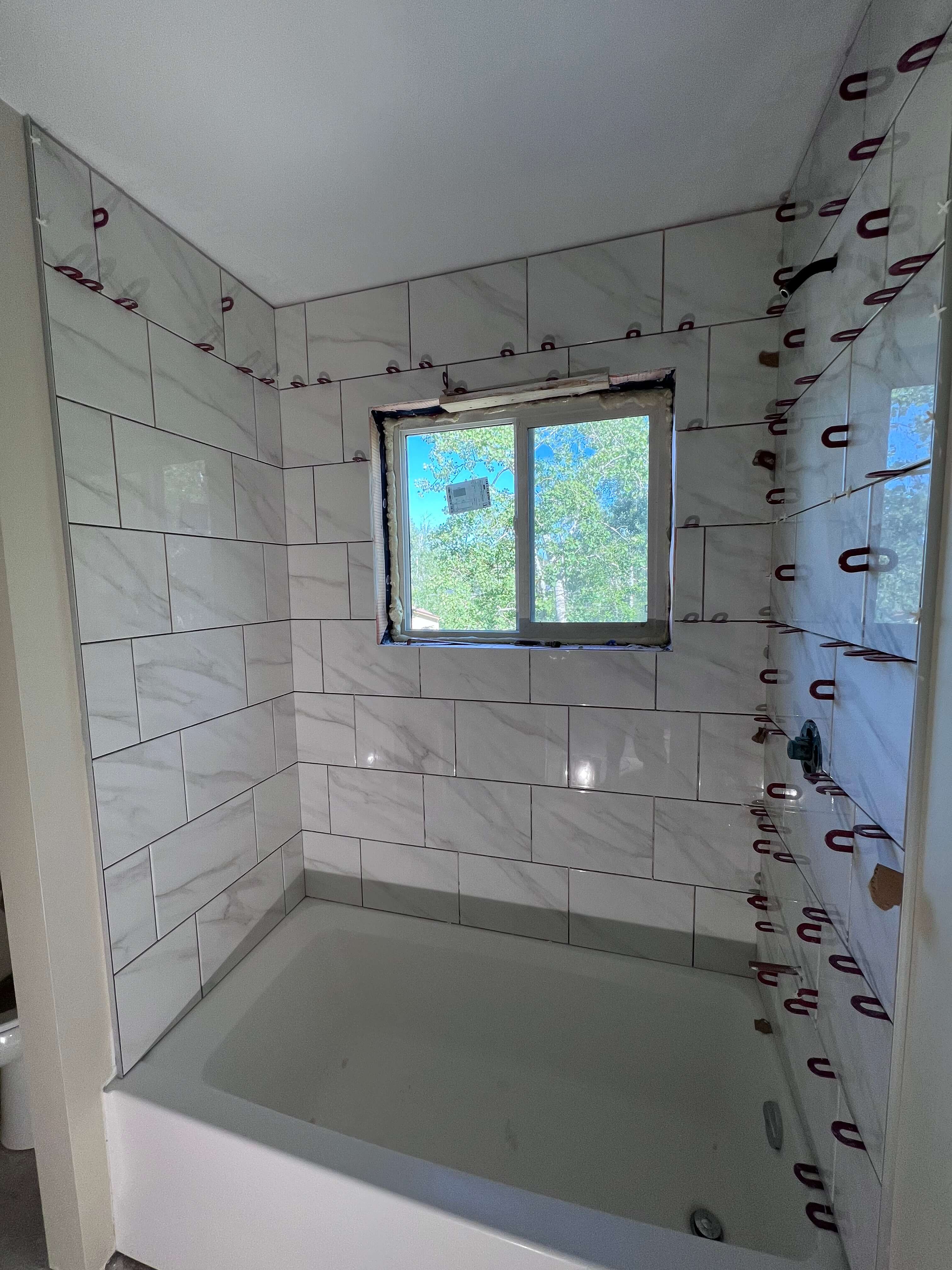 New white tiles installed by the shower