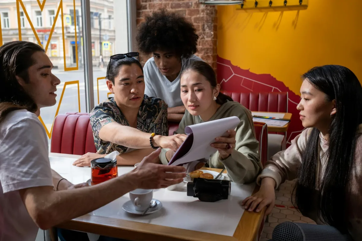 Group of students in a discussion around a table