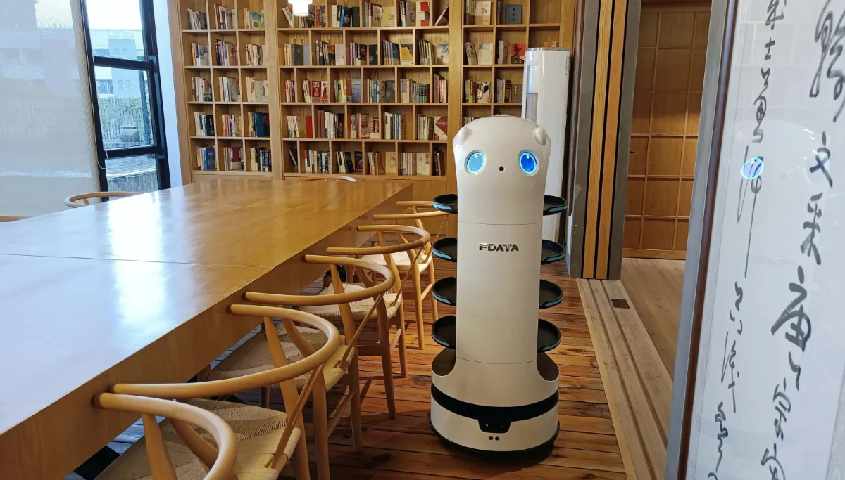 Robot moving through a library reading room