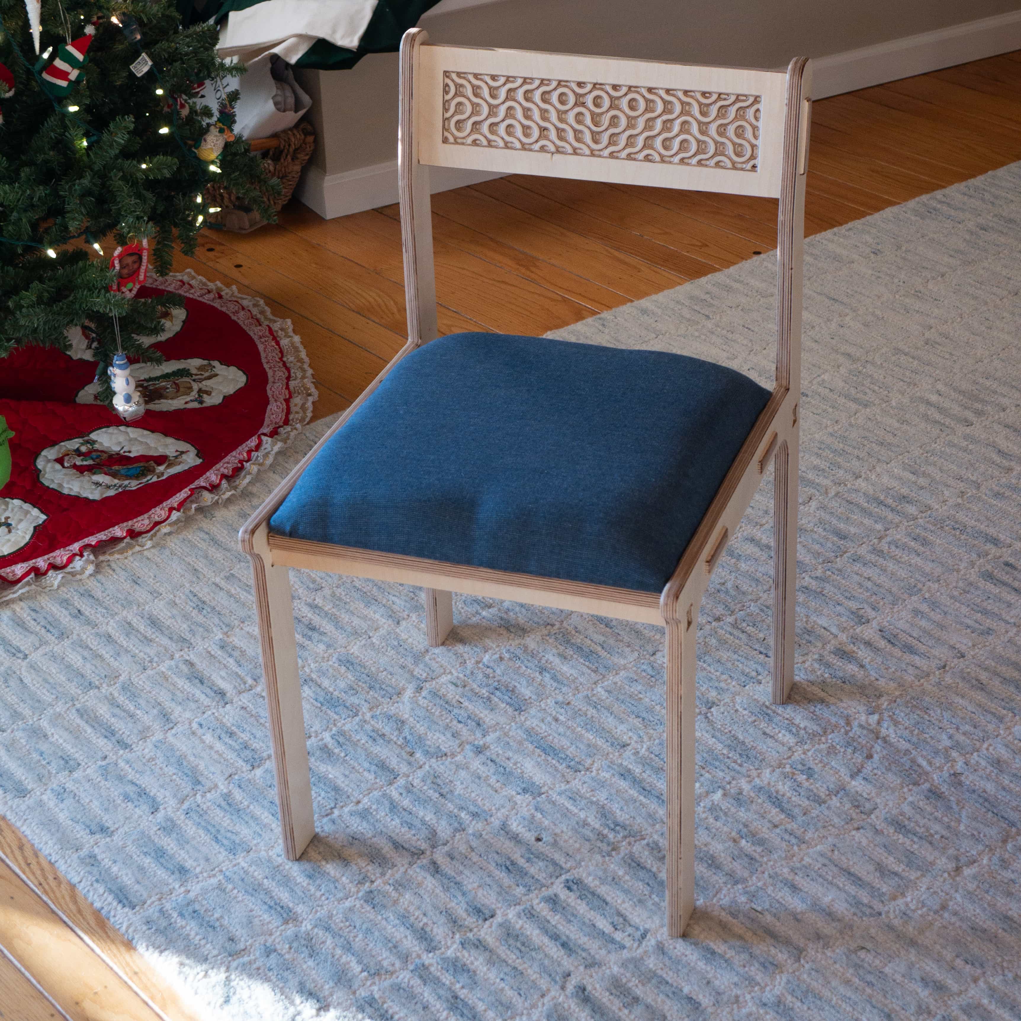 Bitewise smart restaurant recommendation device, featuring a white box with a QR code, a blue button, an embedded thermal printer, and a spring-mounted decorative chef hat, set against a blurred, warmly lit background.