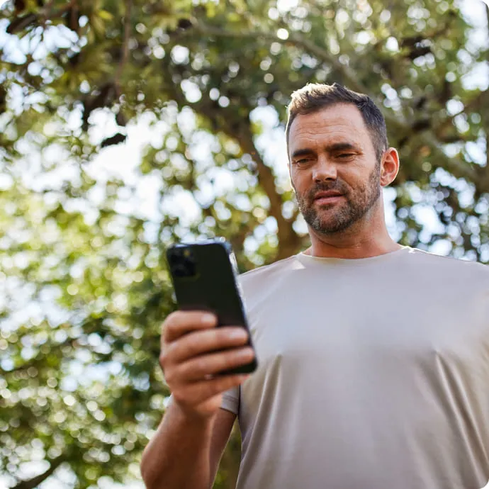 Man looking at his phone outside
