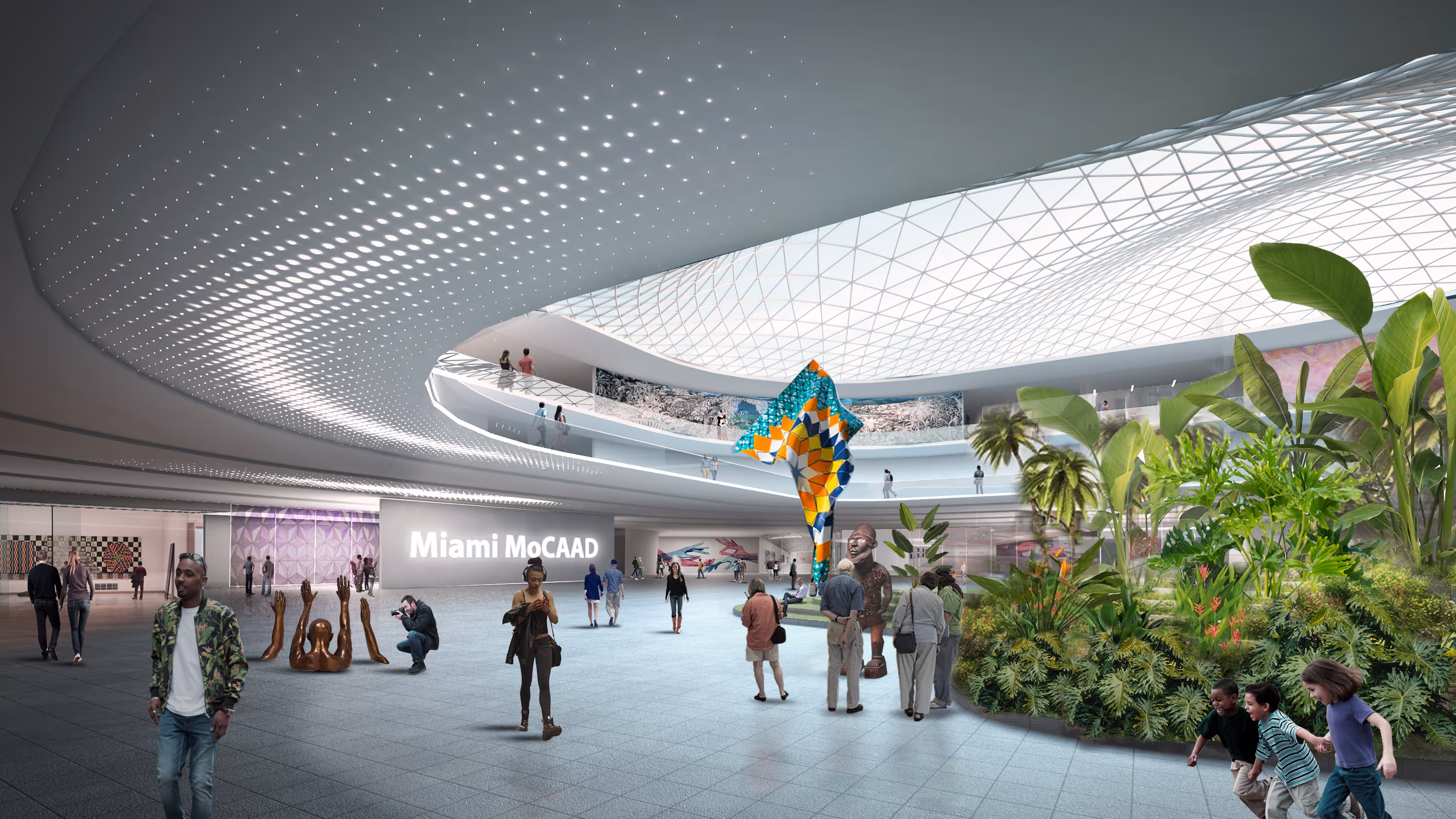Spacious modern indoor sculpture garden at Miami MoCAAD with people viewing art and lush greenery under a large skylight ceiling.