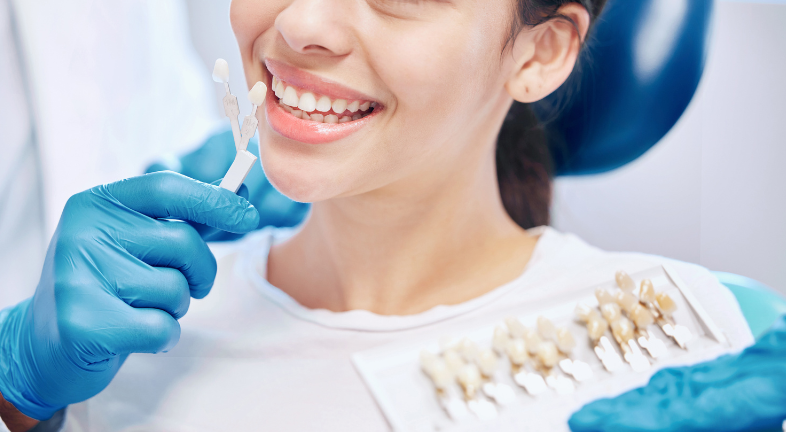 A woman gets colour-matched for dental veneers