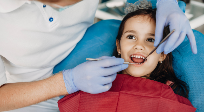 A little girl is getting her dental check-up 