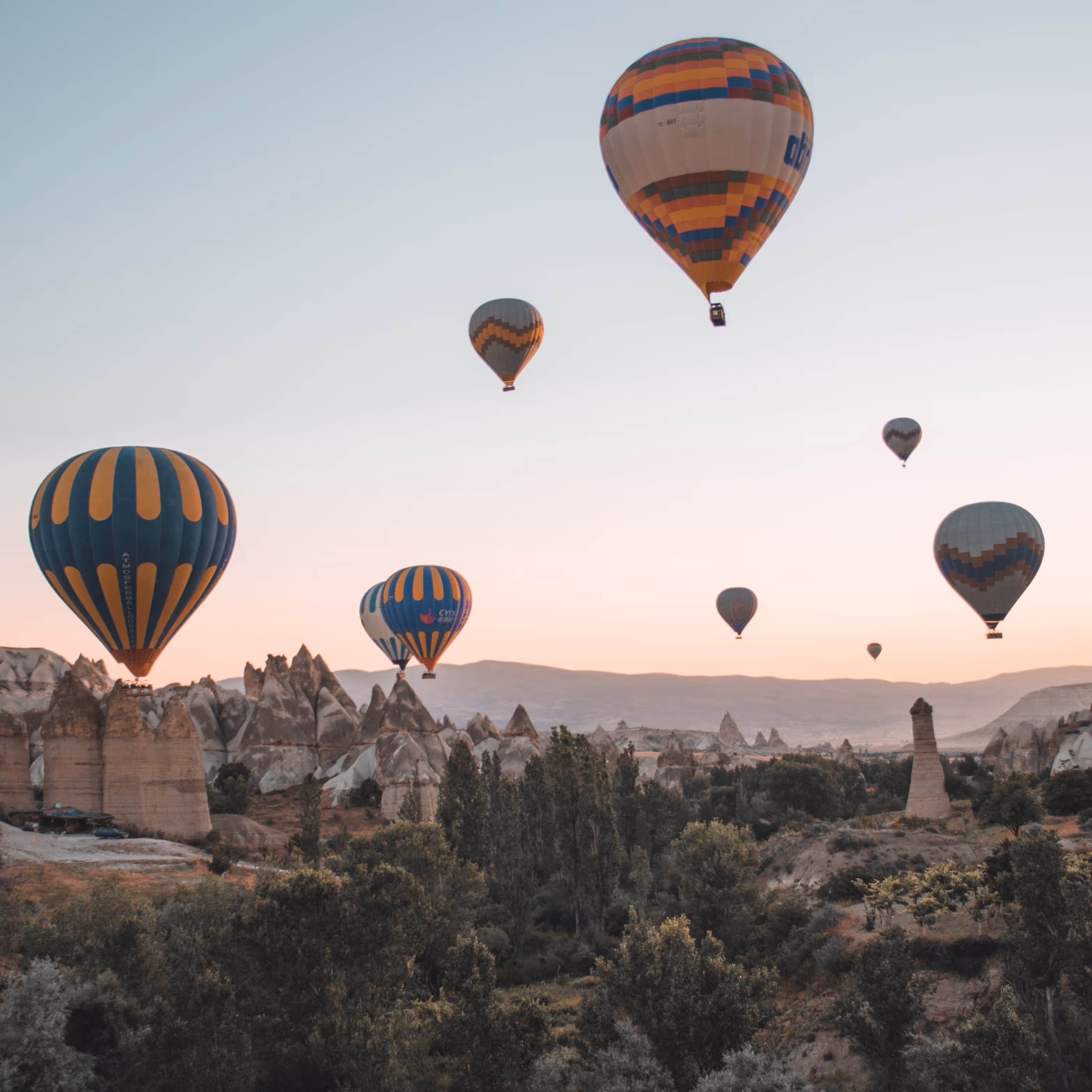 Air balloons rising in early morning dessert sunrise.