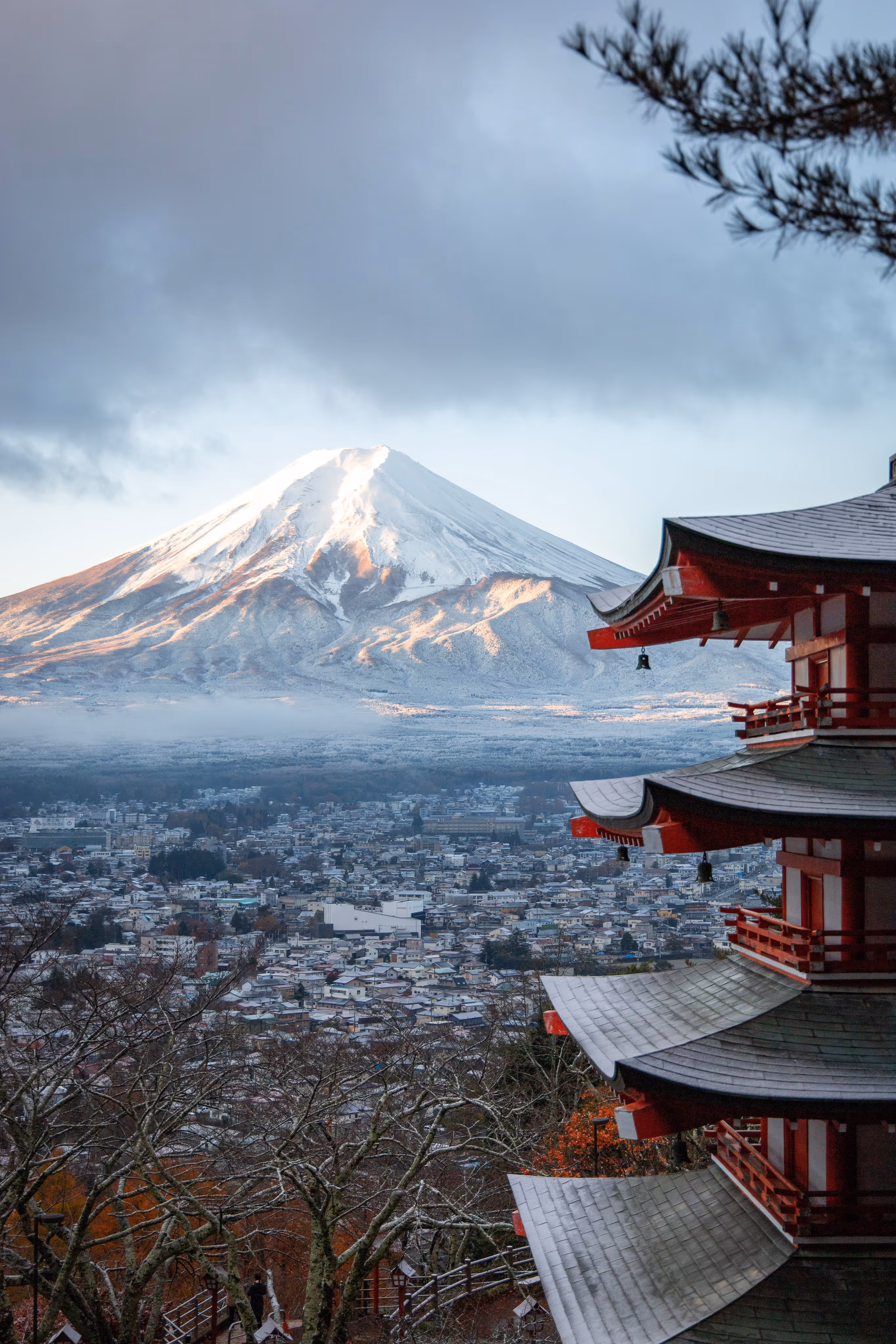 Japanese temple from top level into background mountain view in winter season.