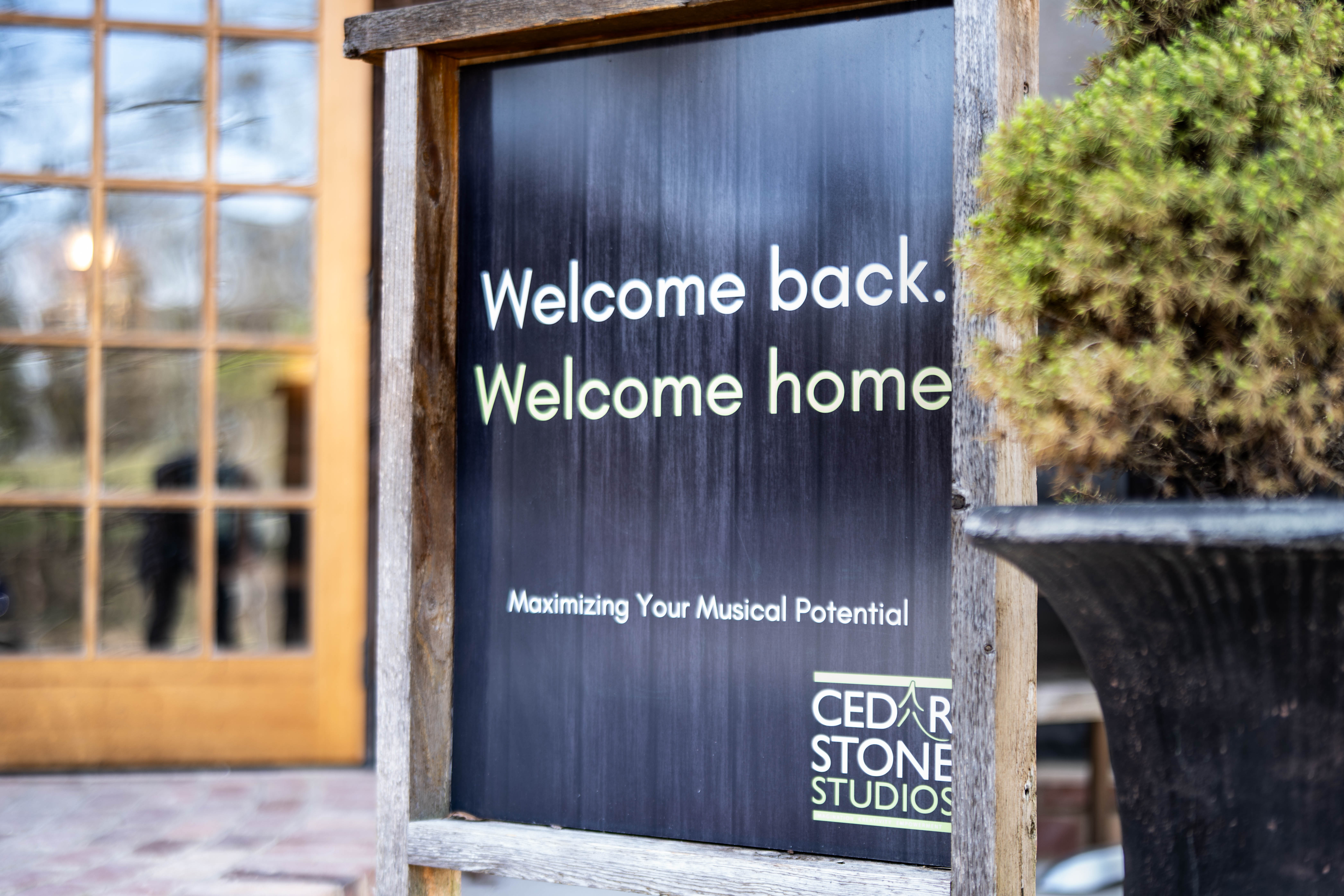 A sign outside Cedarstone Studios reading Welcome back, welcome home