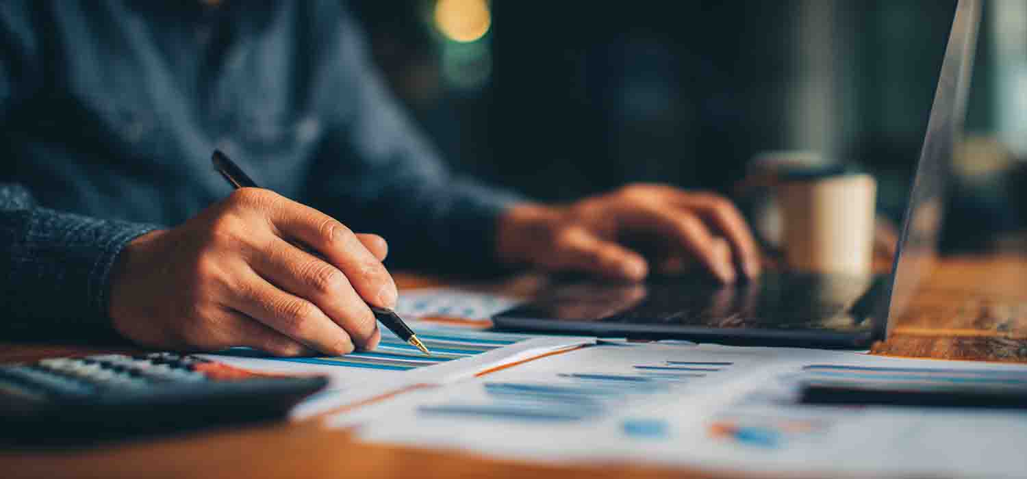 Business owner reviewing managed IT services cost options on a laptop