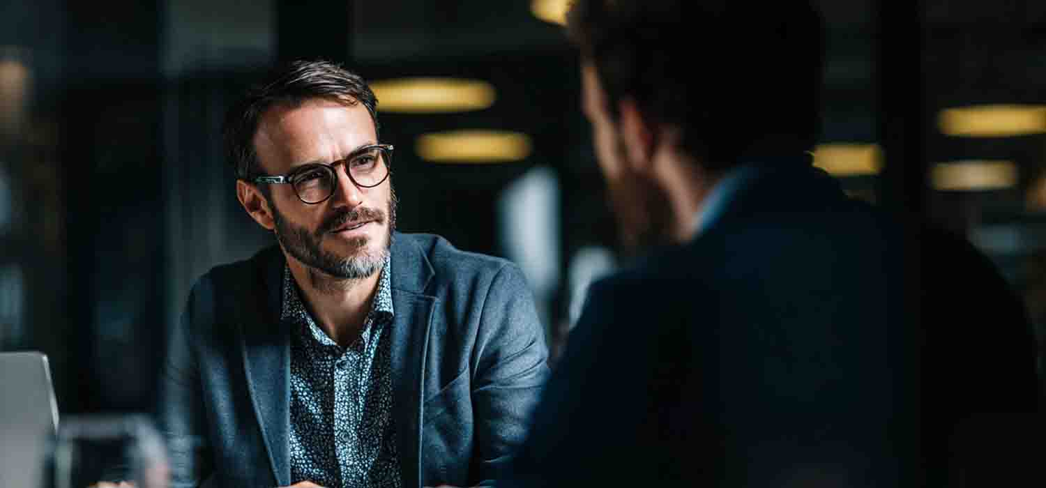 Business owner meeting with a small business IT consultant to discuss technology solutions