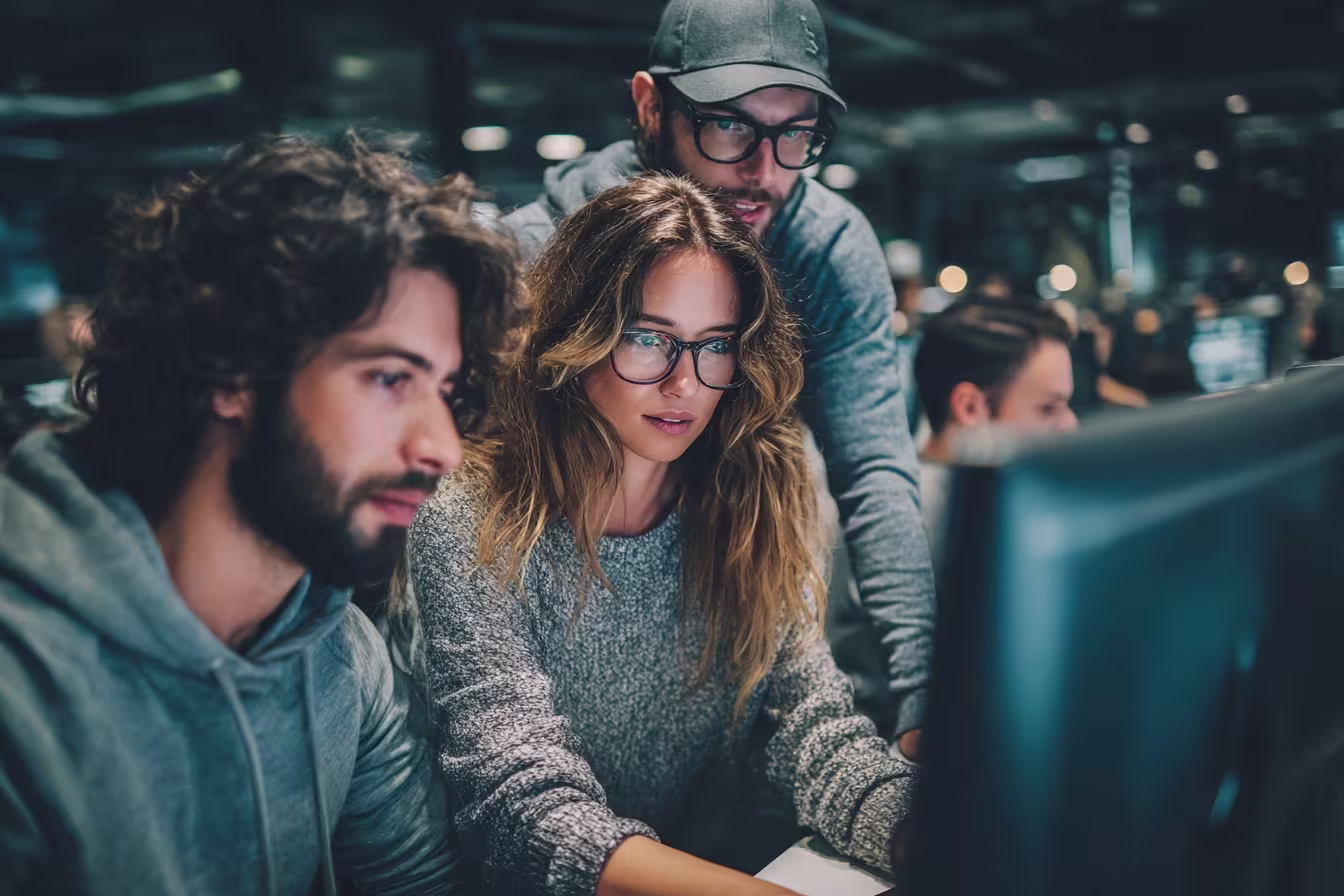 Diverse team collaborating on zero trust security dashboard