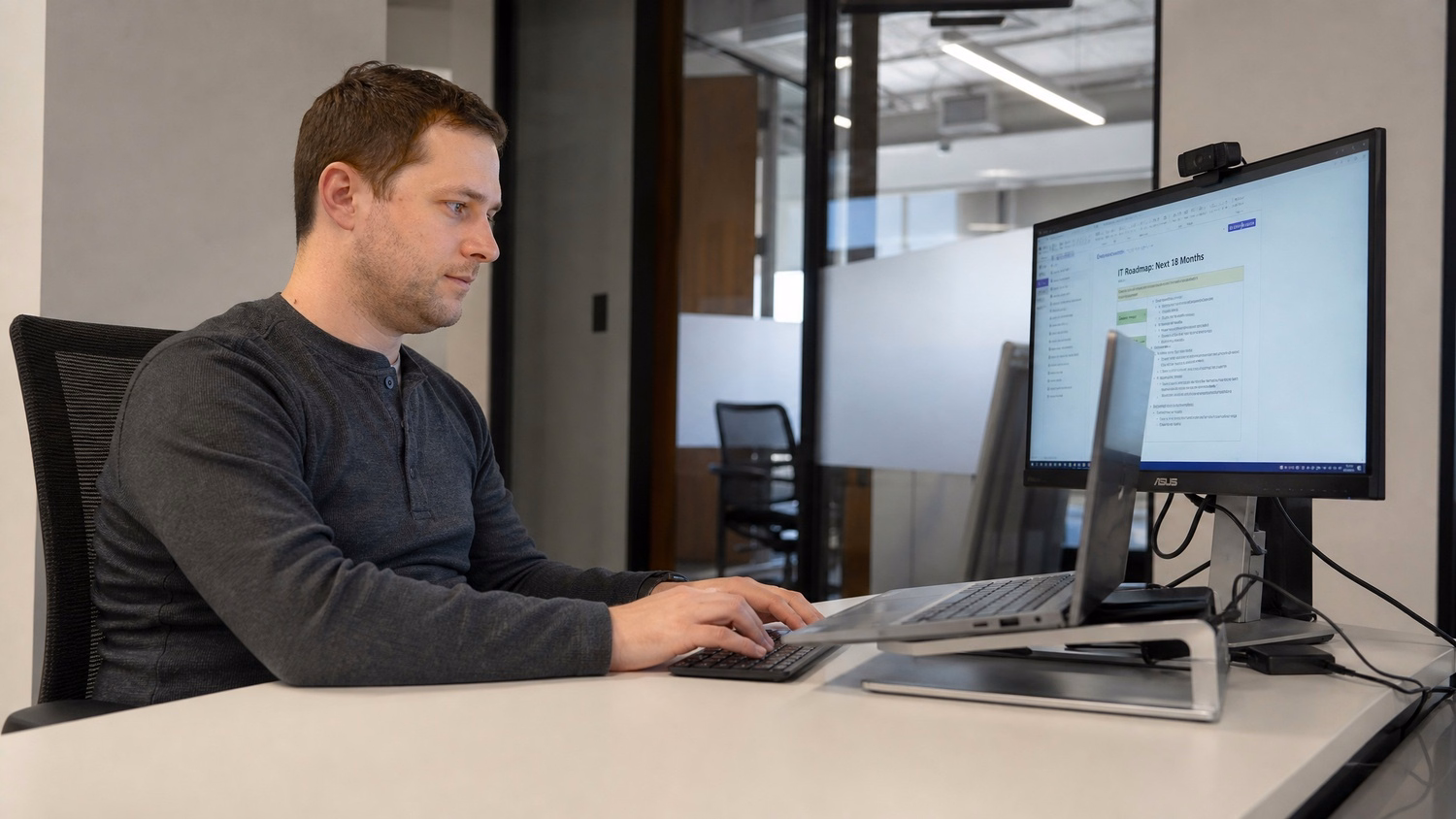 SOLO WORKSTATION An IT professional  one person alone at a single desk with a