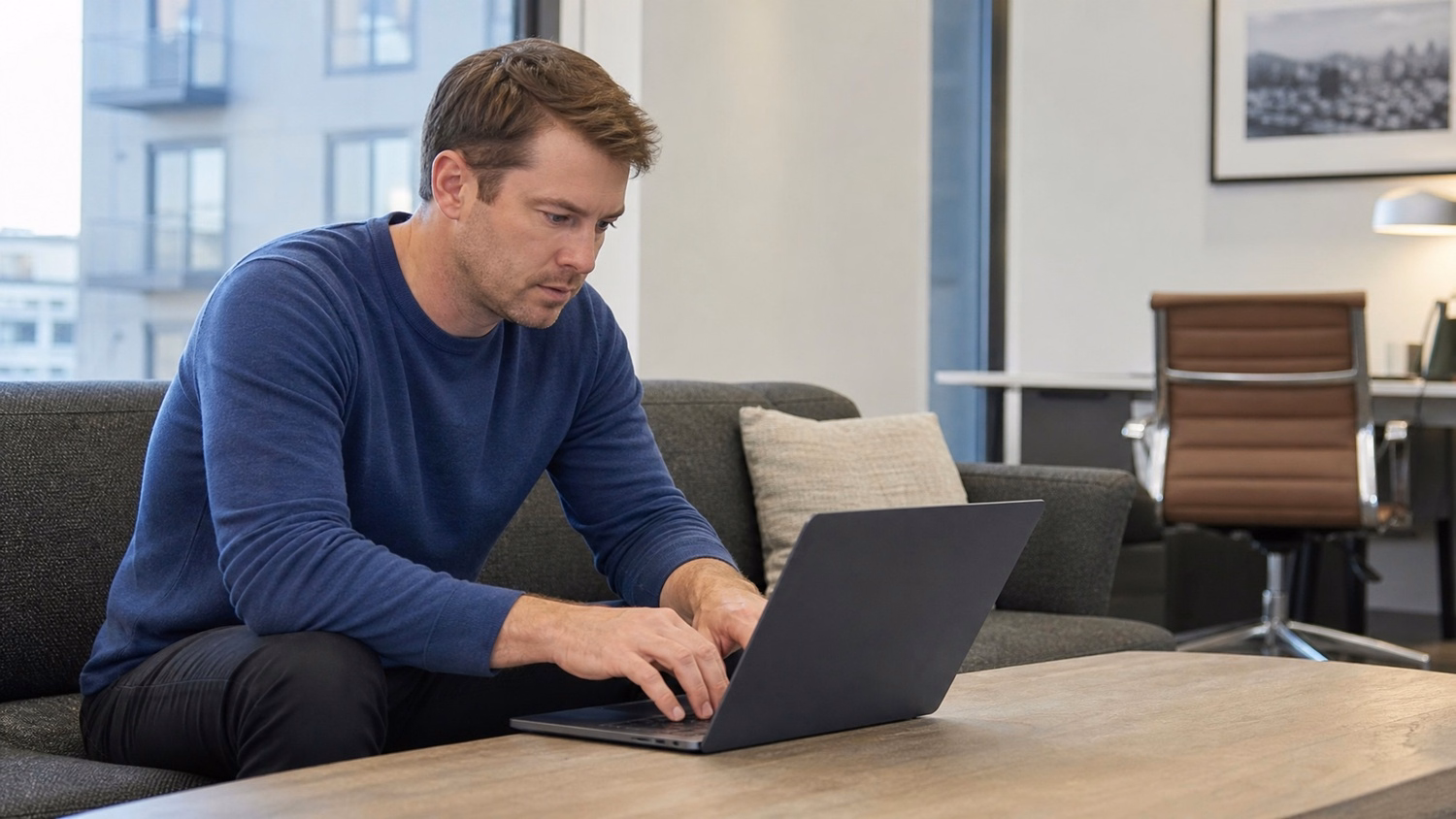 LOUNGE AREA LAPTOP An IT professional one person working on a laptop in a ca