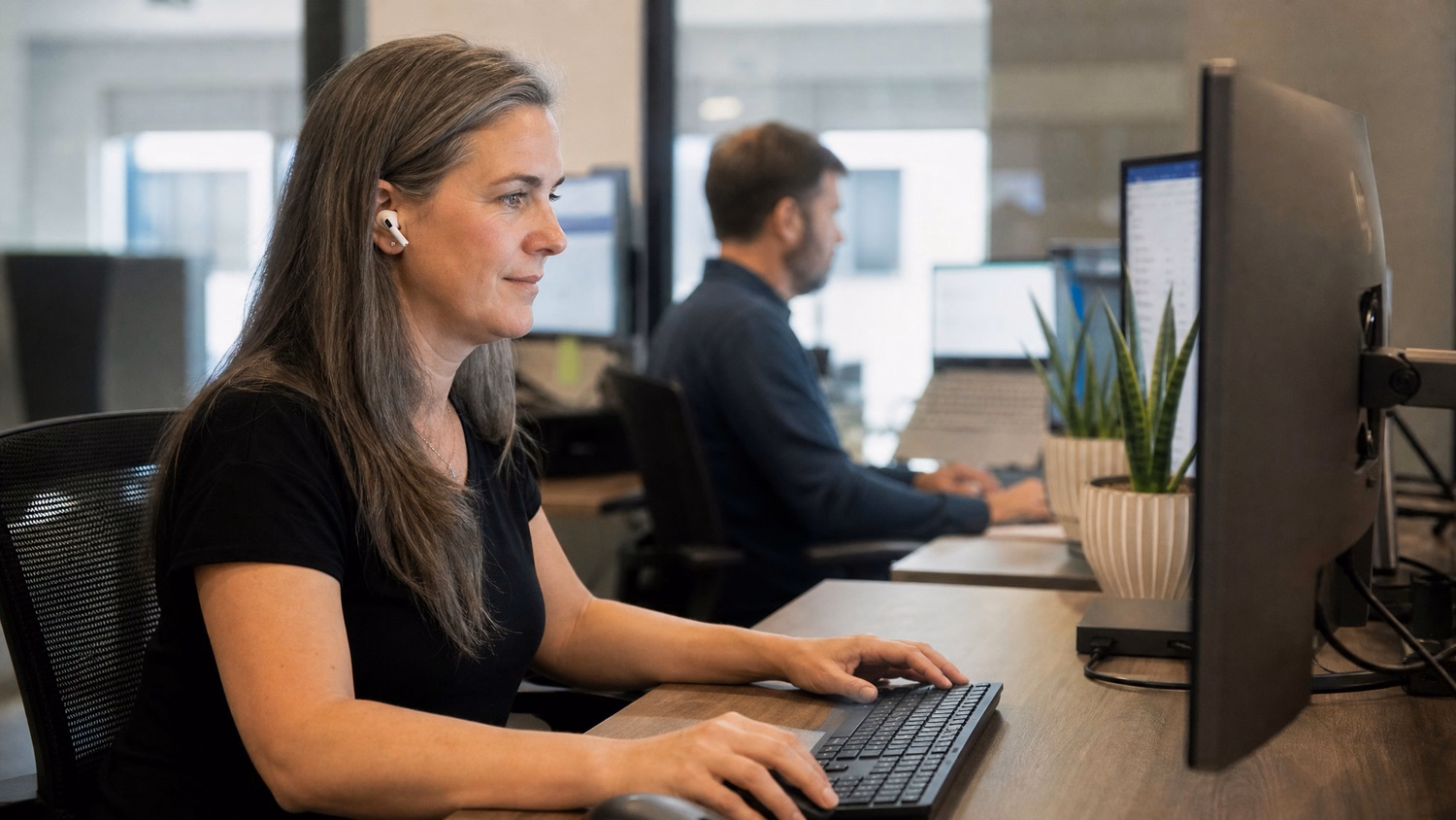 Woman typing on keyboard, setting up app at desk 58