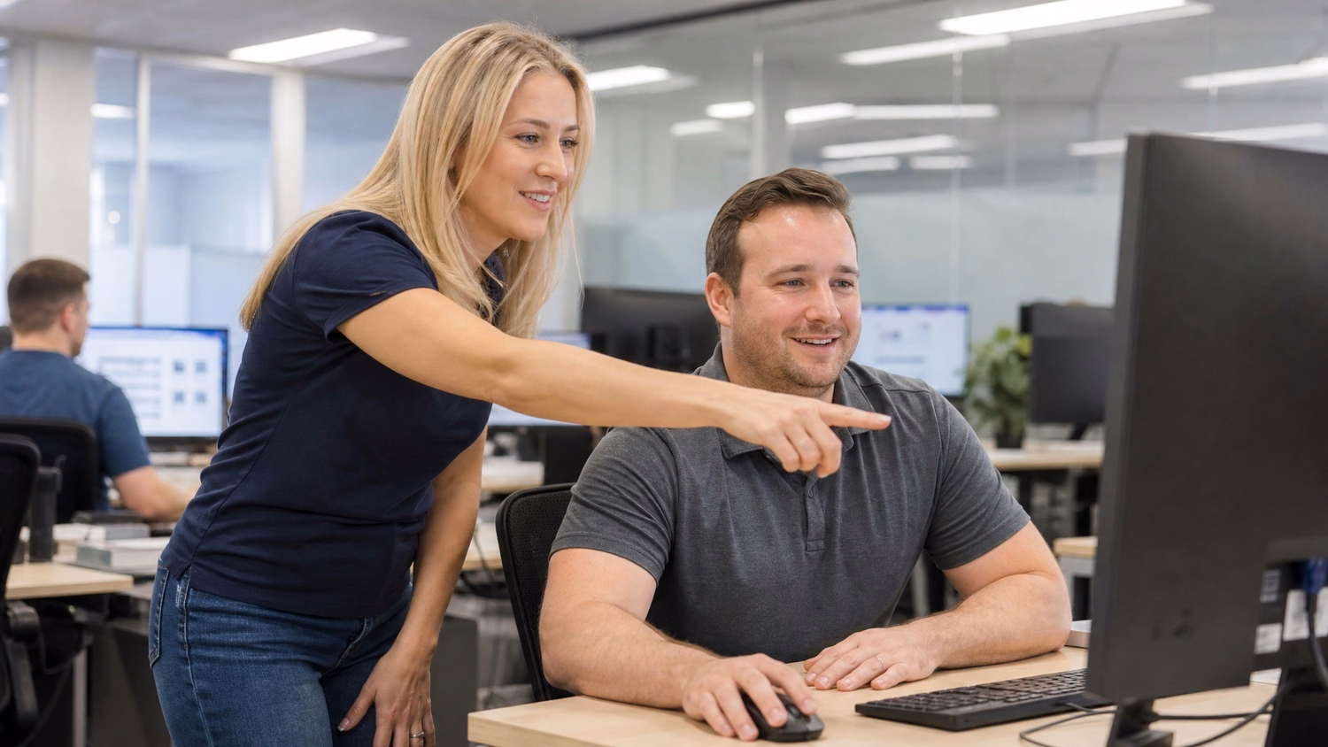 Woman discusses Power Automate workflow at colleagues desk