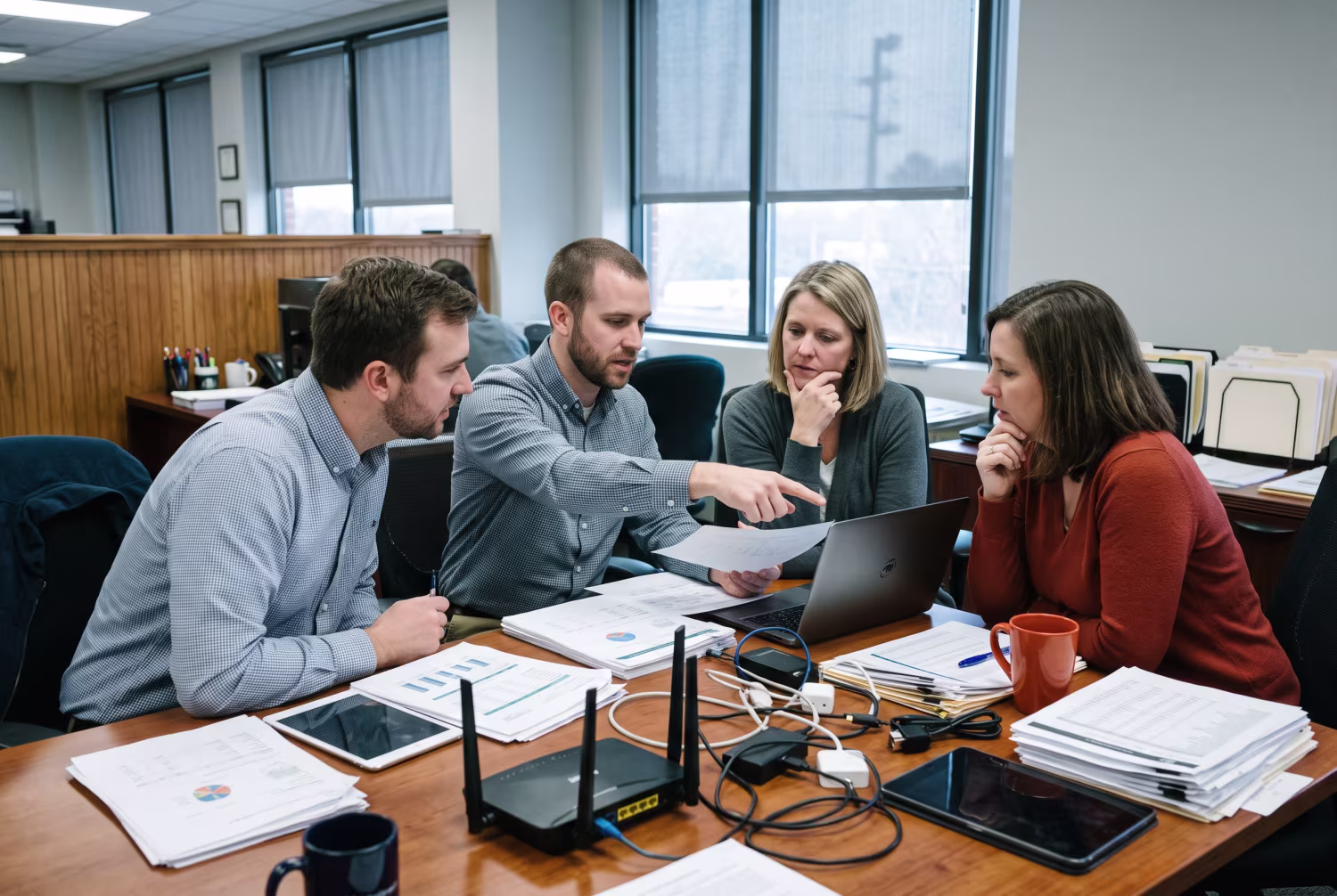 IT professionals examining documents in Charlotte CPA office
