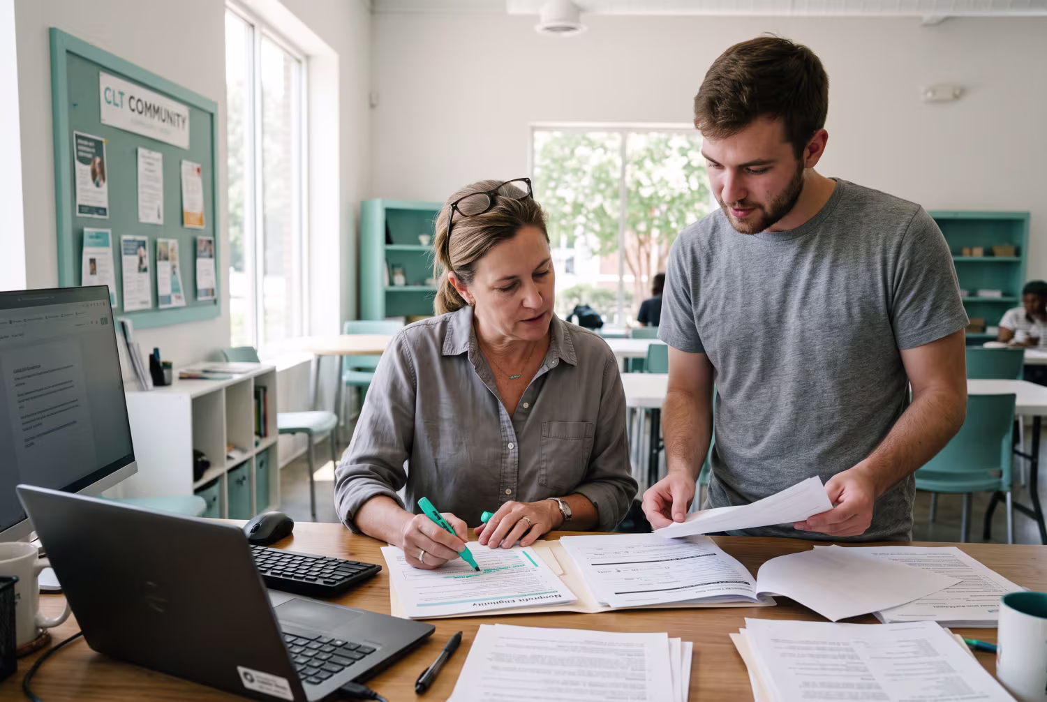 Nonprofit manager and colleague reviewing Microsoft 365 nonprofit qualification forms