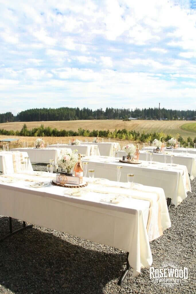 Table settings for a reception held outside of the barn.