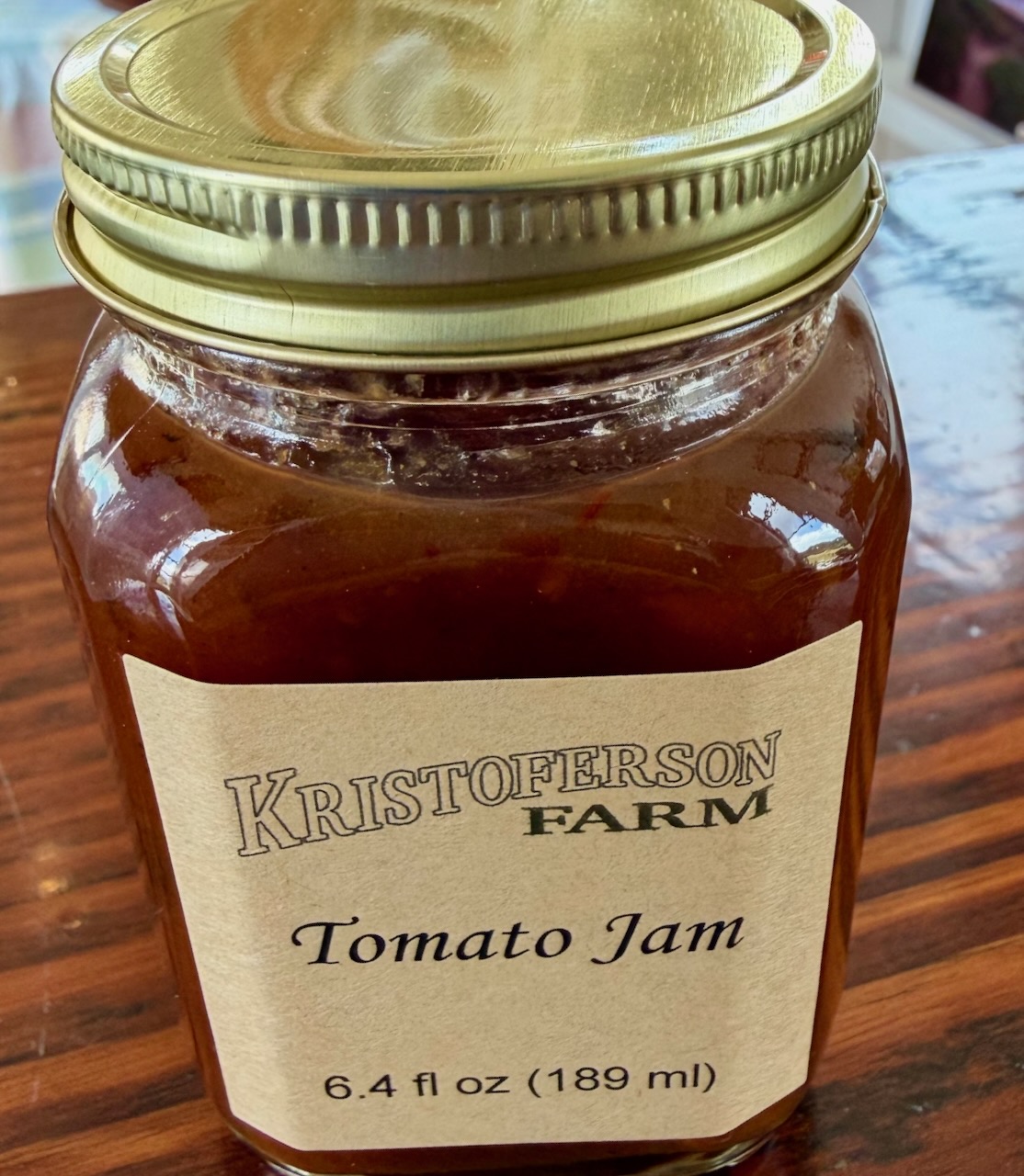Glass jars of fresh tomato jam, handmade on our farm.